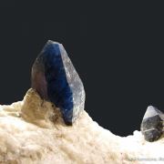 Afghanite (TL) (fl) on Calcite (fl)