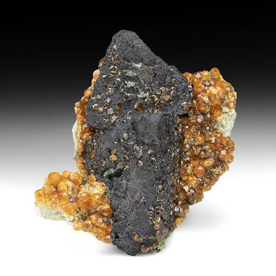 Goethite after Helvite with Spessartine